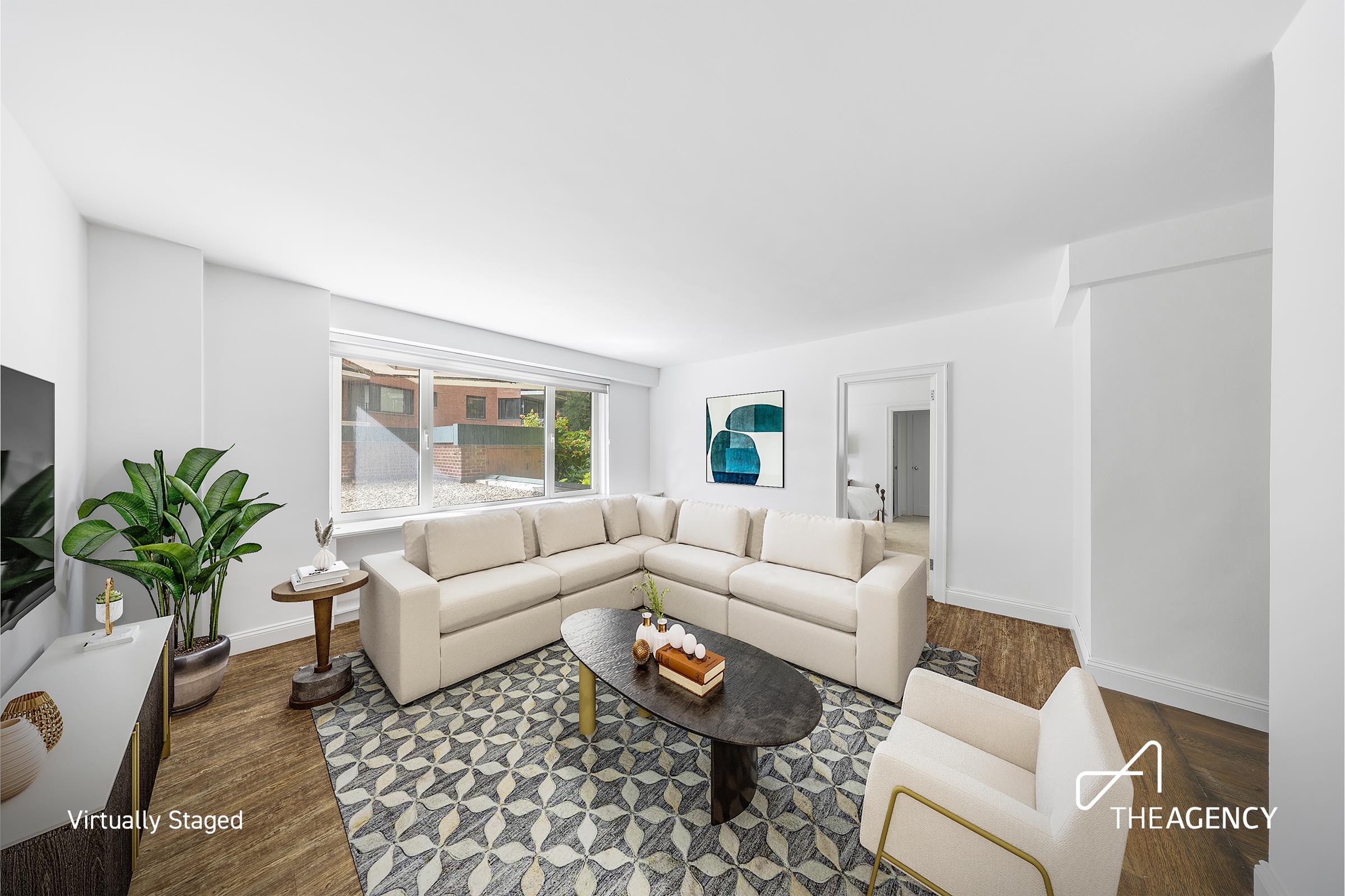 a living room with furniture and a potted plant