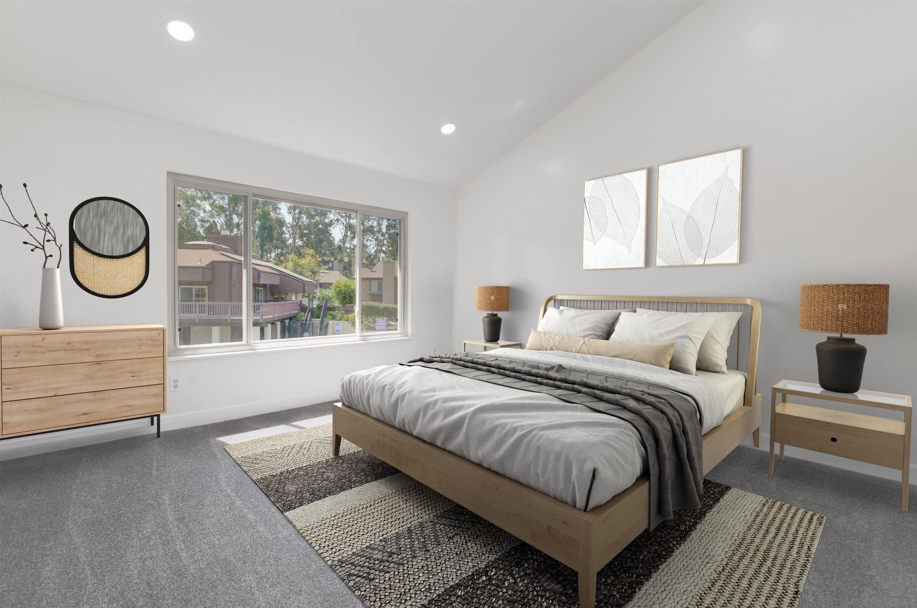 a bedroom with a bed mirror and window