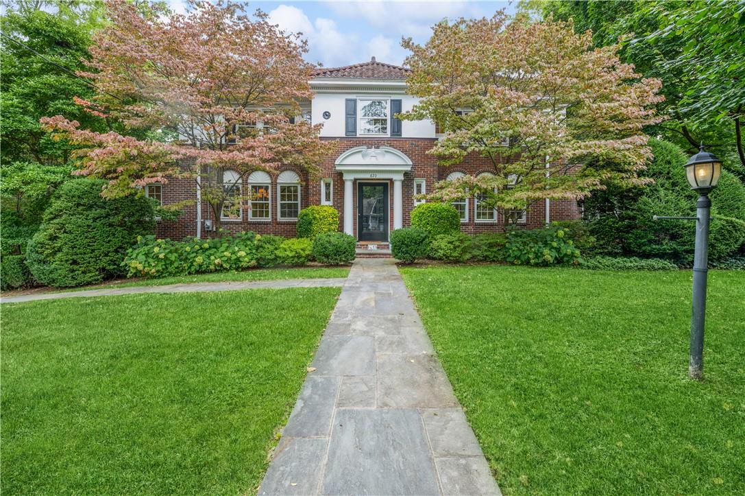 a front view of a house with a yard