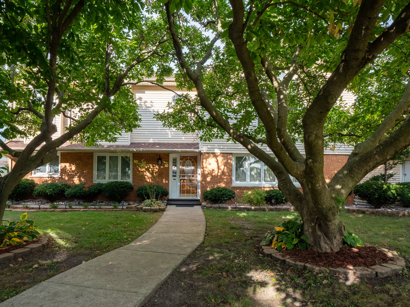 a front view of a house with a yard