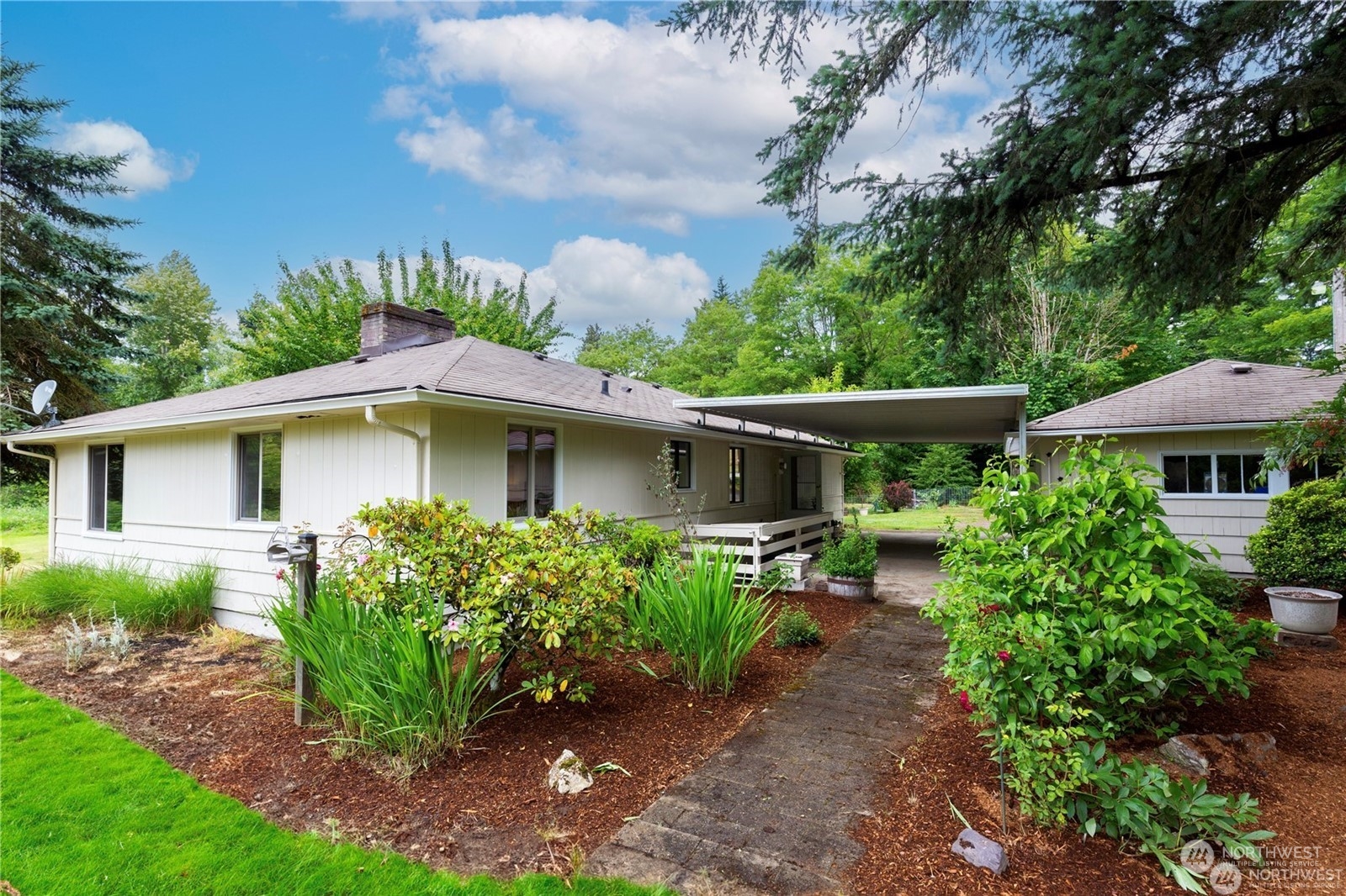 a front view of house with yard and trees