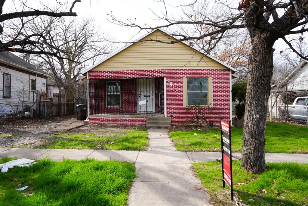 a front view of a house with yard and green space