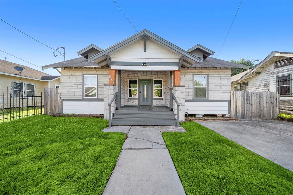 a front view of a house with a yard and outdoor seating