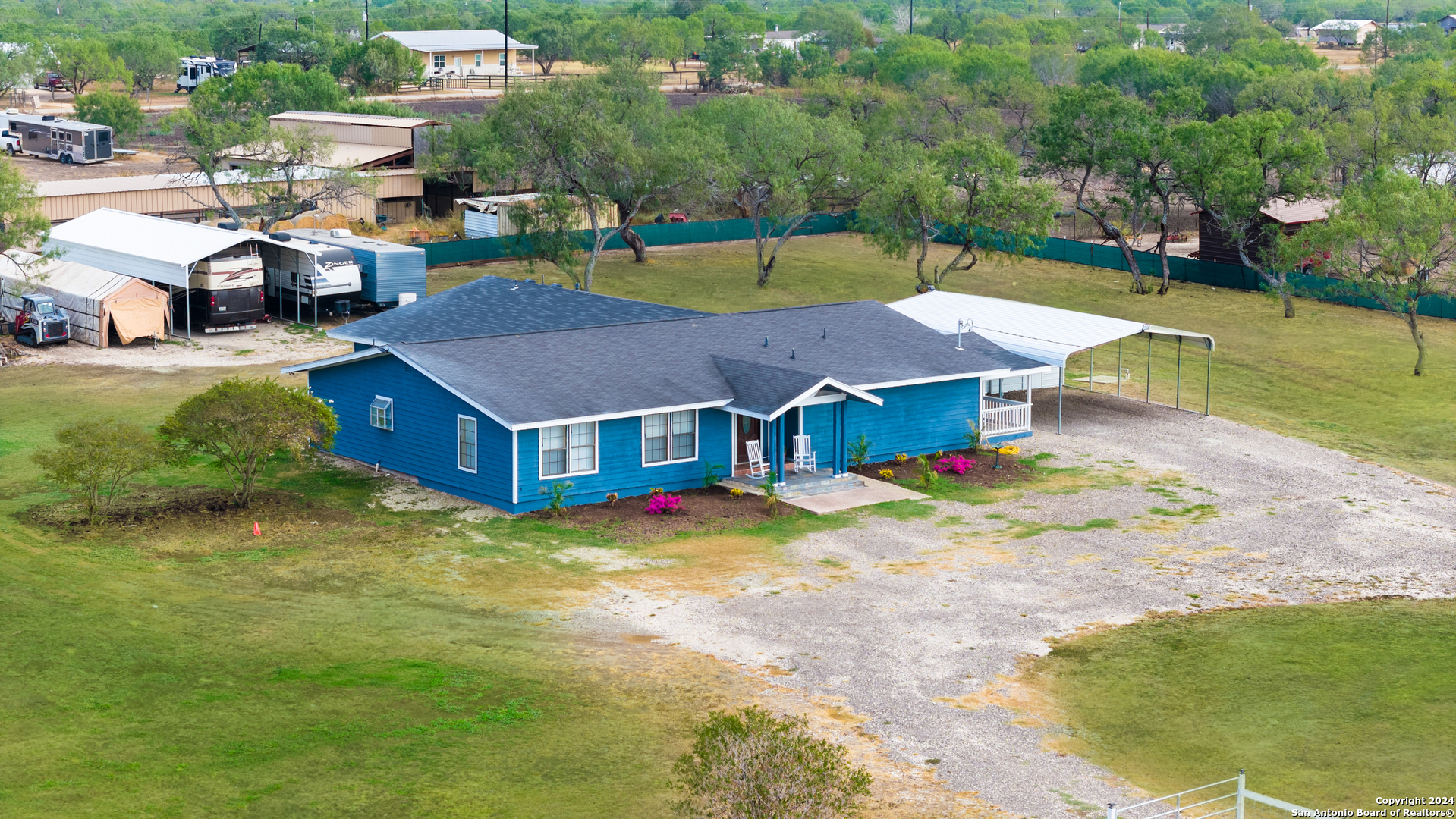 an aerial view of a house with swimming pool lawn chairs and yard