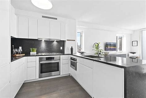 a kitchen with granite countertop white cabinets and white appliances