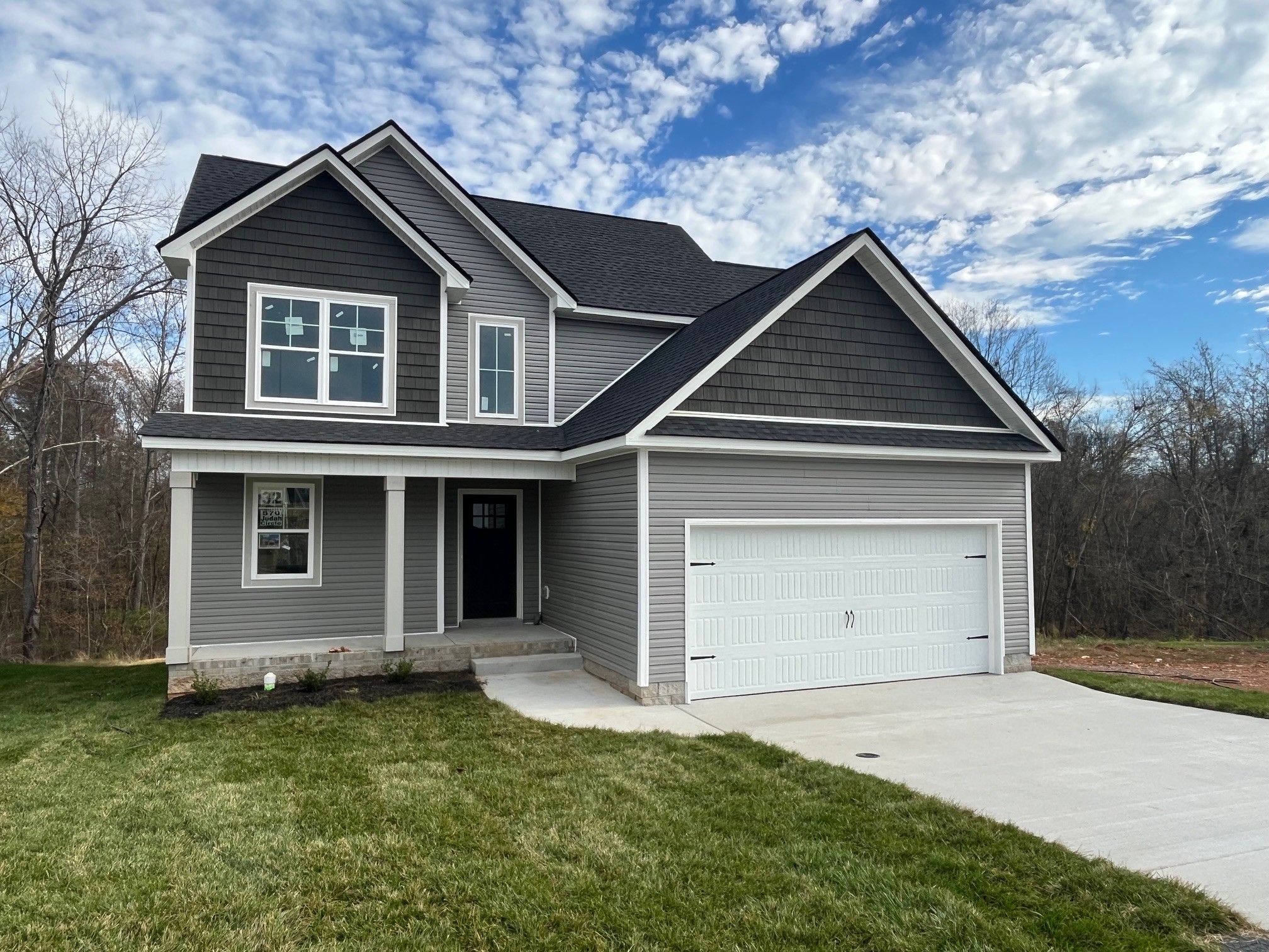 a view of a house with a yard and garage