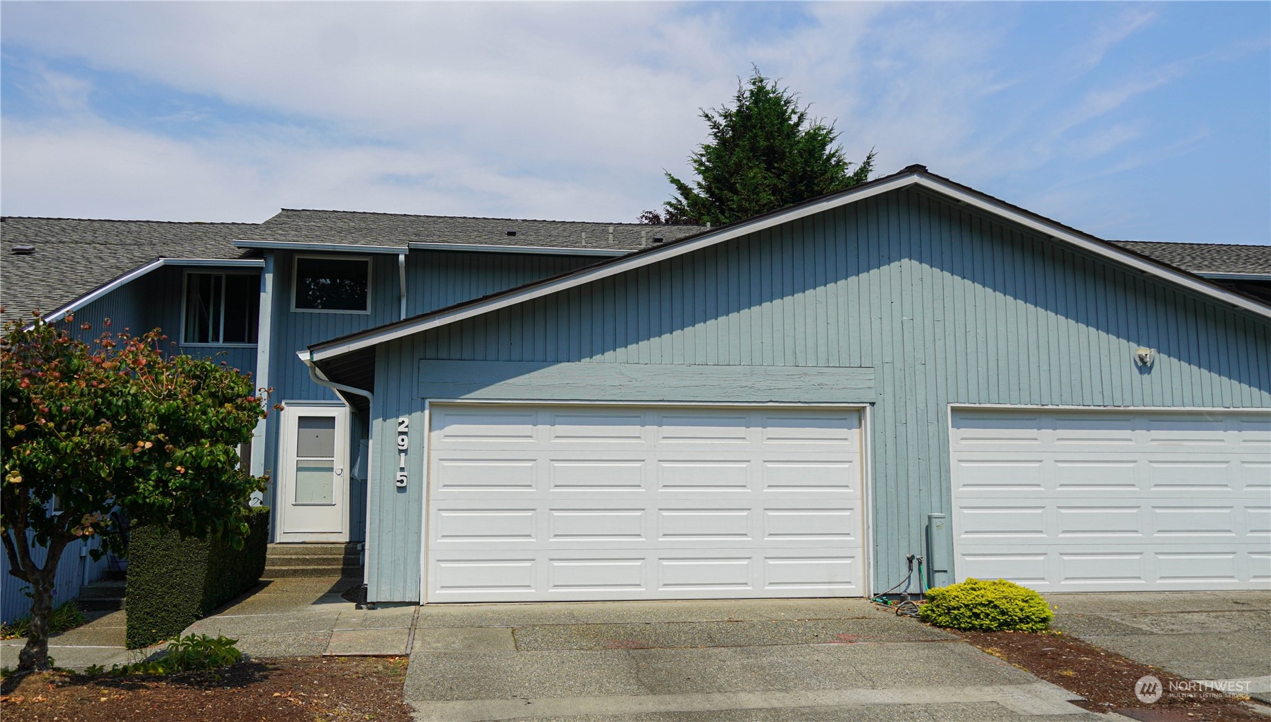 a front view of a house with garage