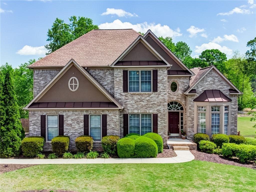 a front view of a house with a yard