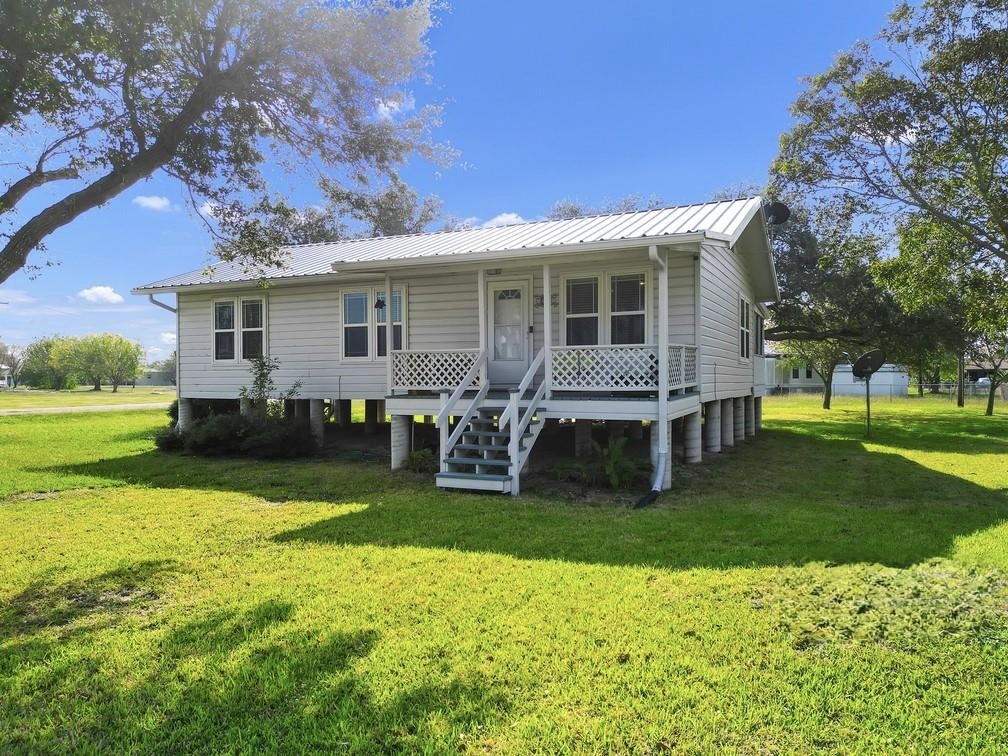 a view of a house with a yard porch and sitting area