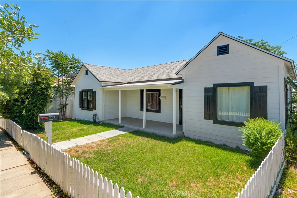 a front view of house with yard and green space