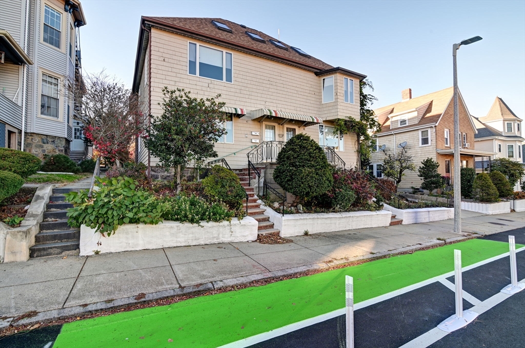 a front view of a house with garden