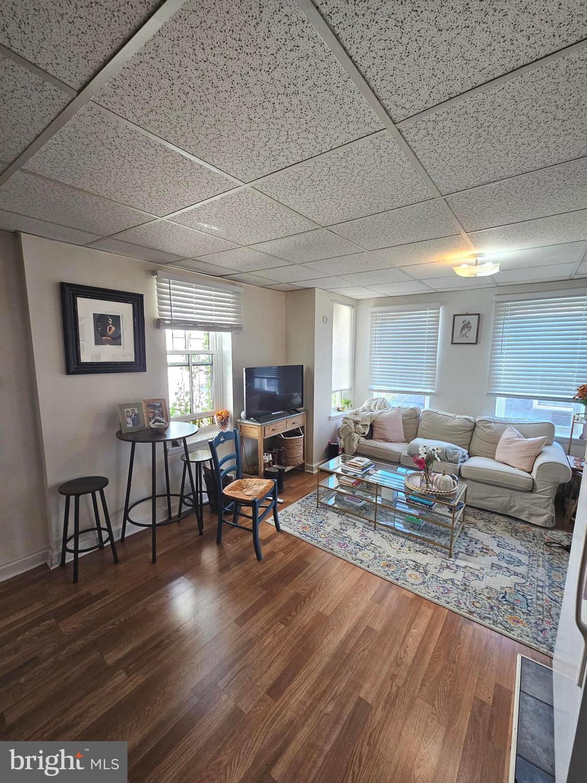 a living room with fireplace furniture and a wooden floor