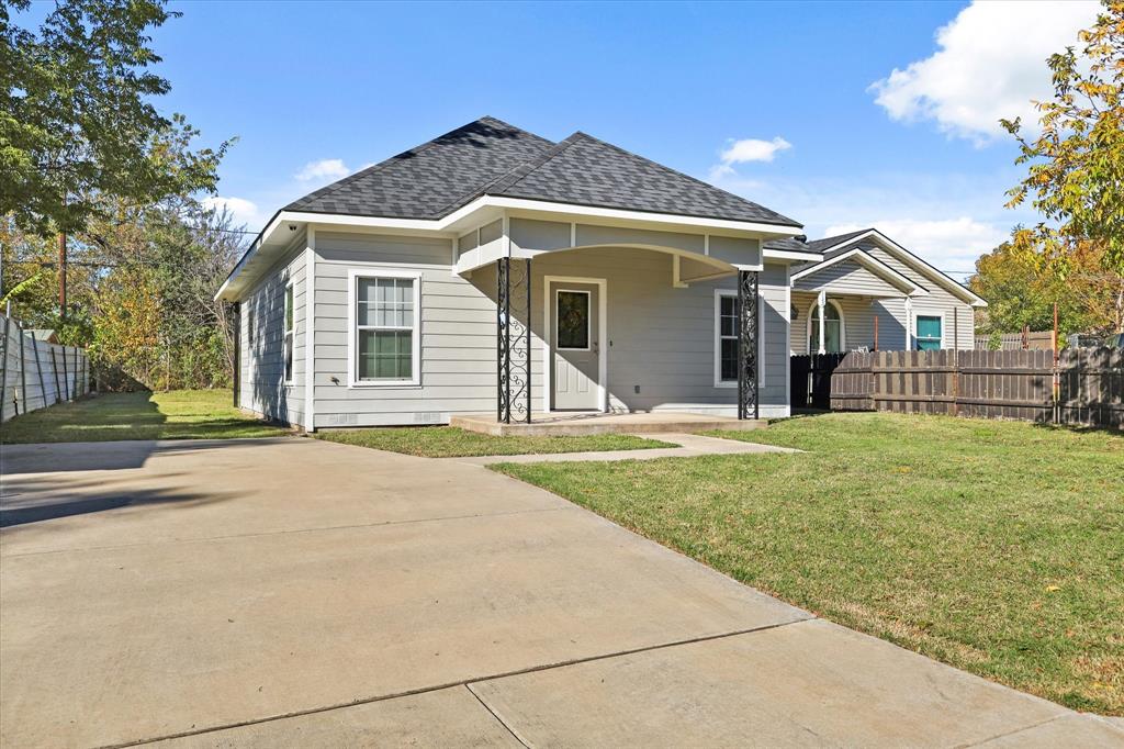 View of front of home with a front lawn and covered porch