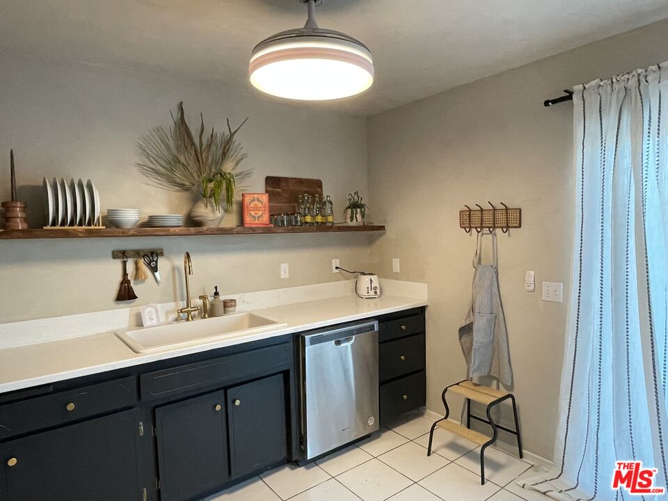 a bathroom with a sink a mirror and a potted plant