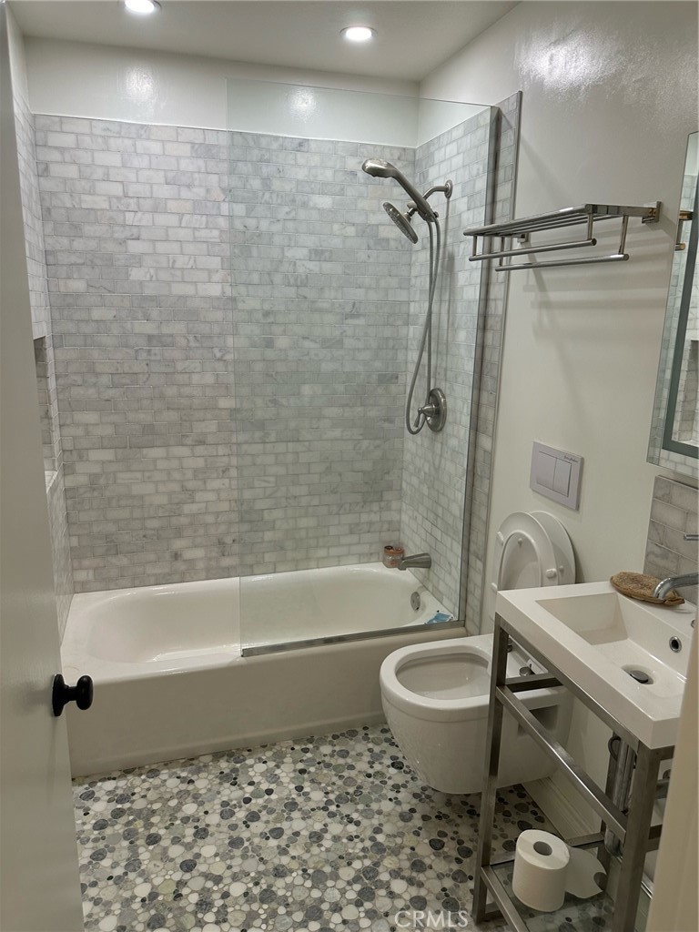 a bathroom with a toilet a sink and bathtub