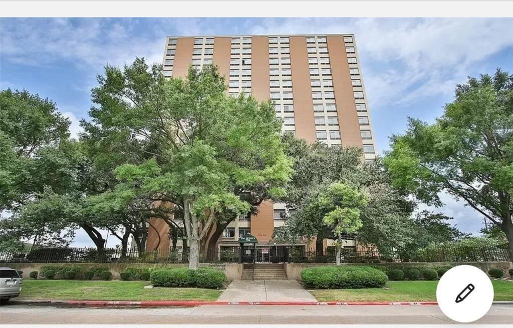 a front view of a building with tree s