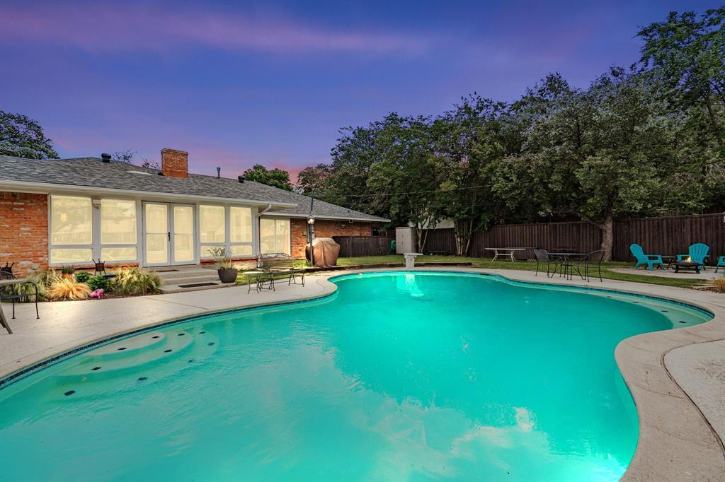 a view of a house with swimming pool and sitting area