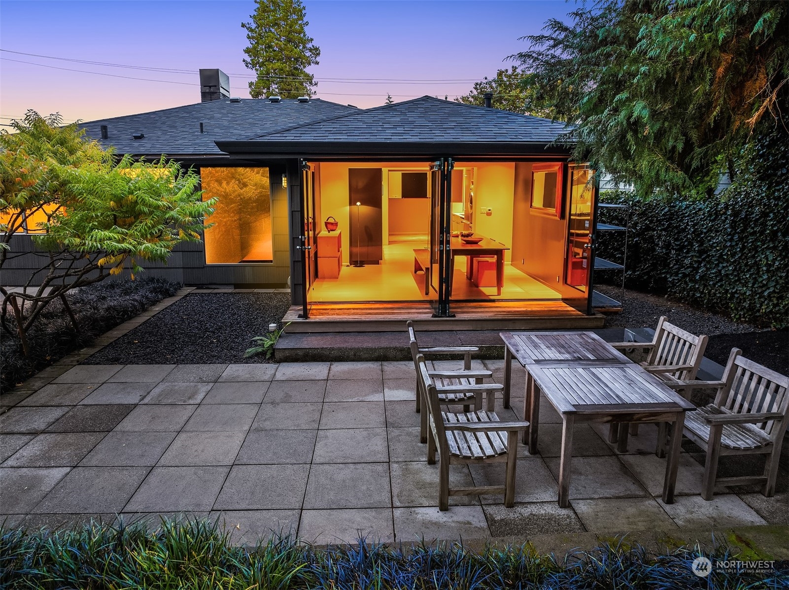 a backyard of a house with table and chairs