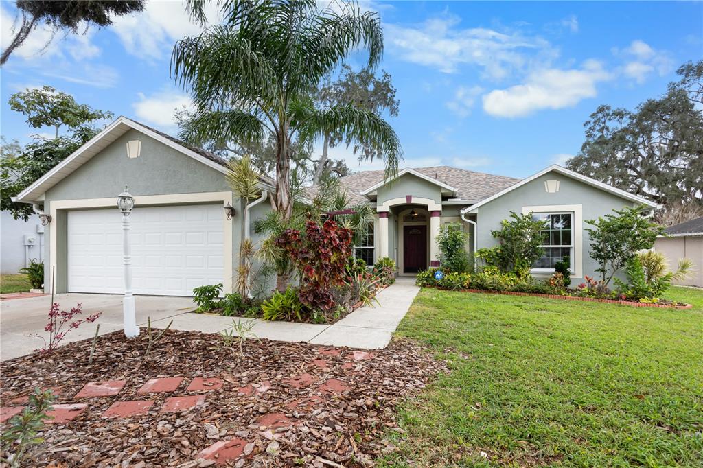 a front view of a house with a yard and garage