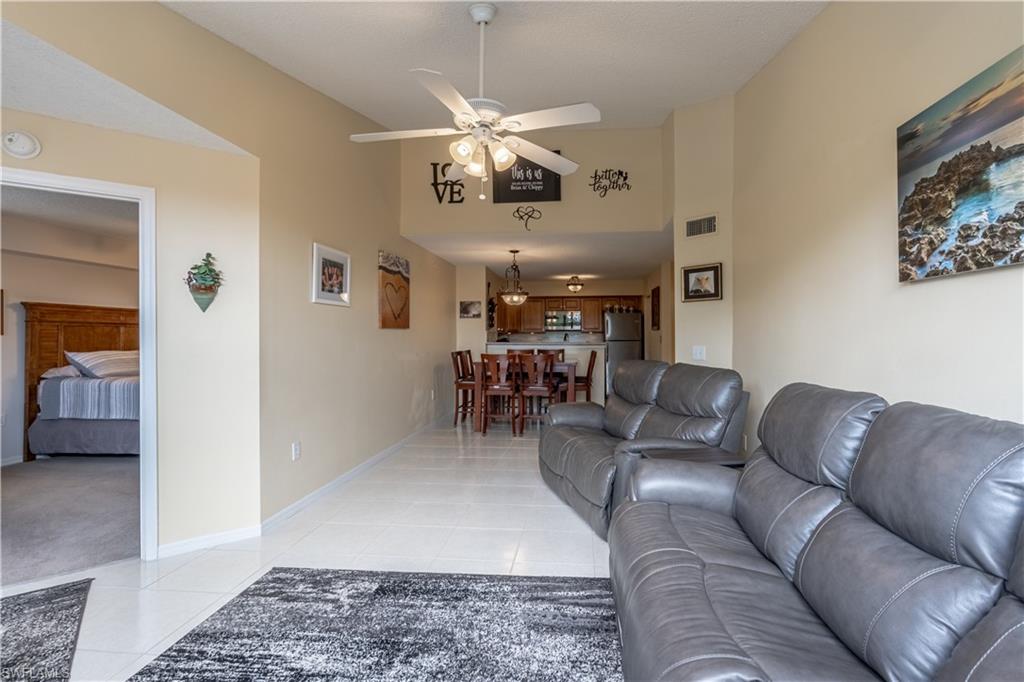 a living room with furniture and kitchen view