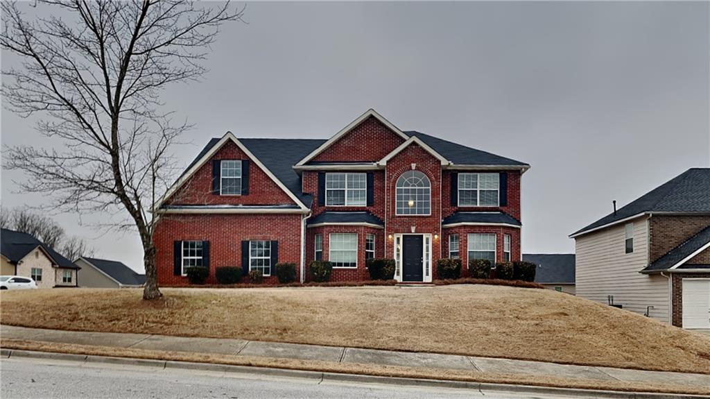 a front view of a house with a yard and garage