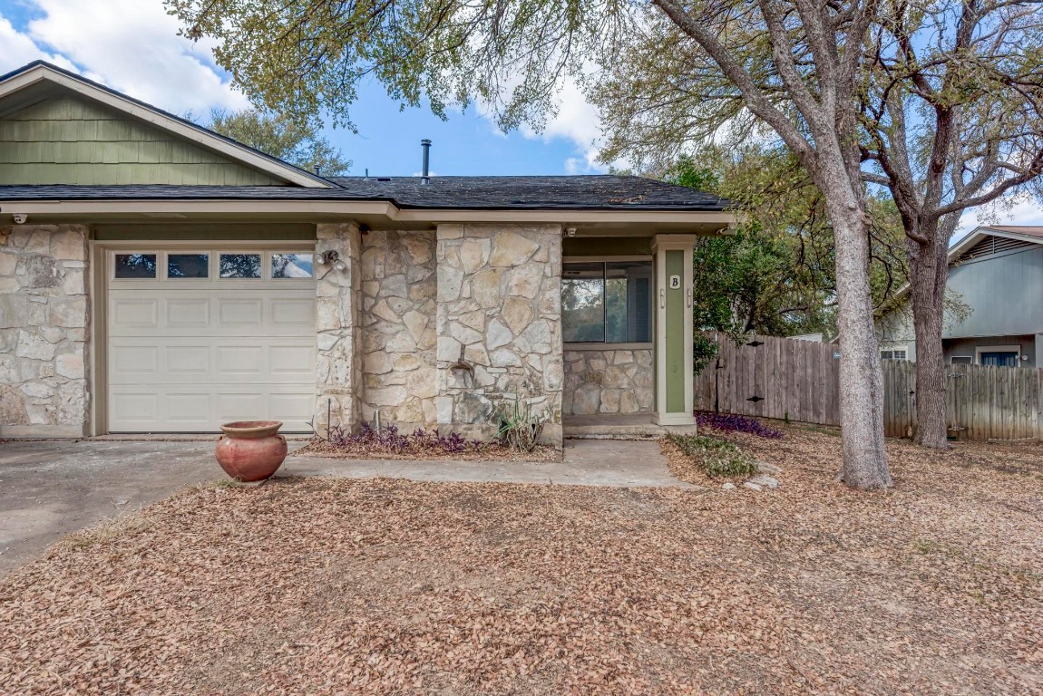 a backyard of a house with barbeque oven and outdoor seating