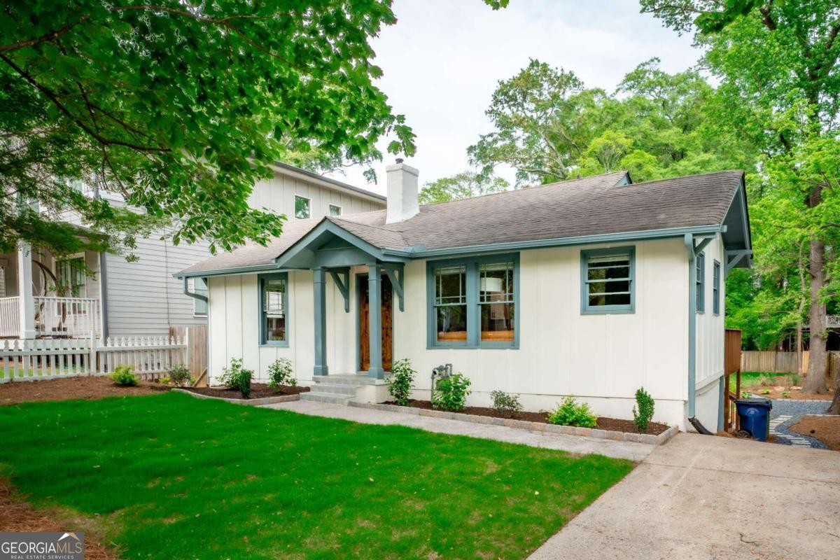 a front view of a house with a yard and porch