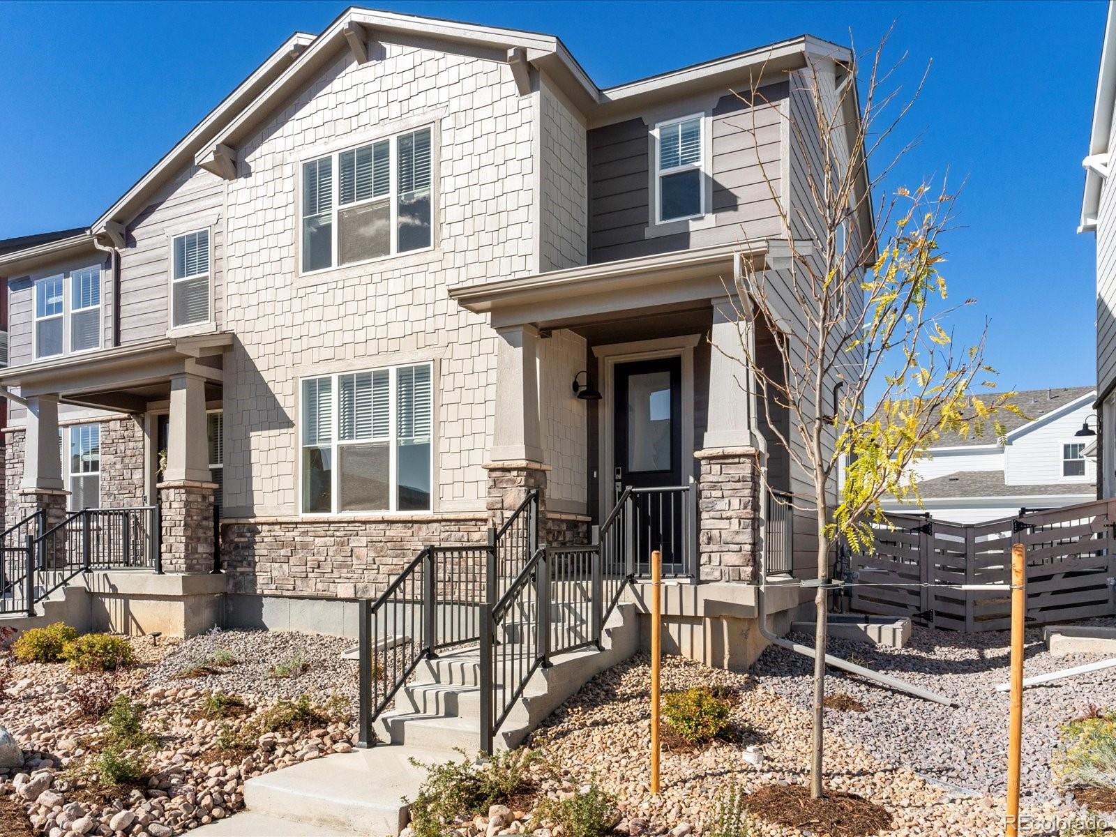 a front view of a house with iron fence