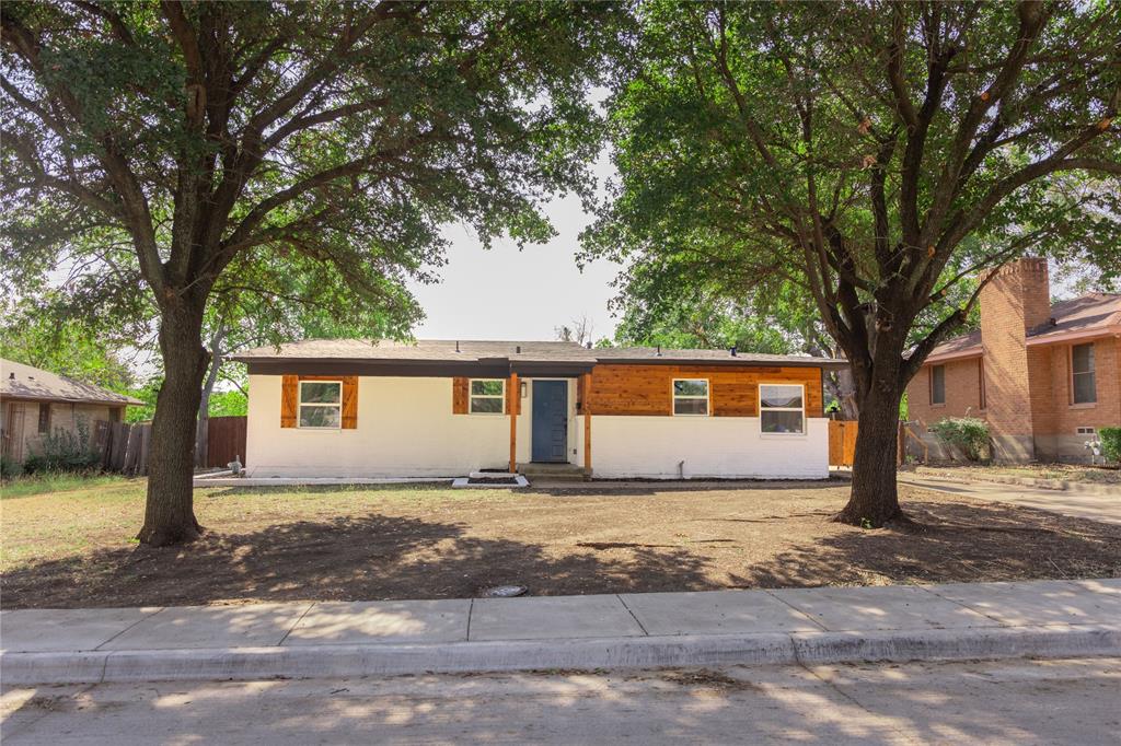 a house that has a tree in front of it