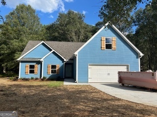 a view of a house with a yard and large tree