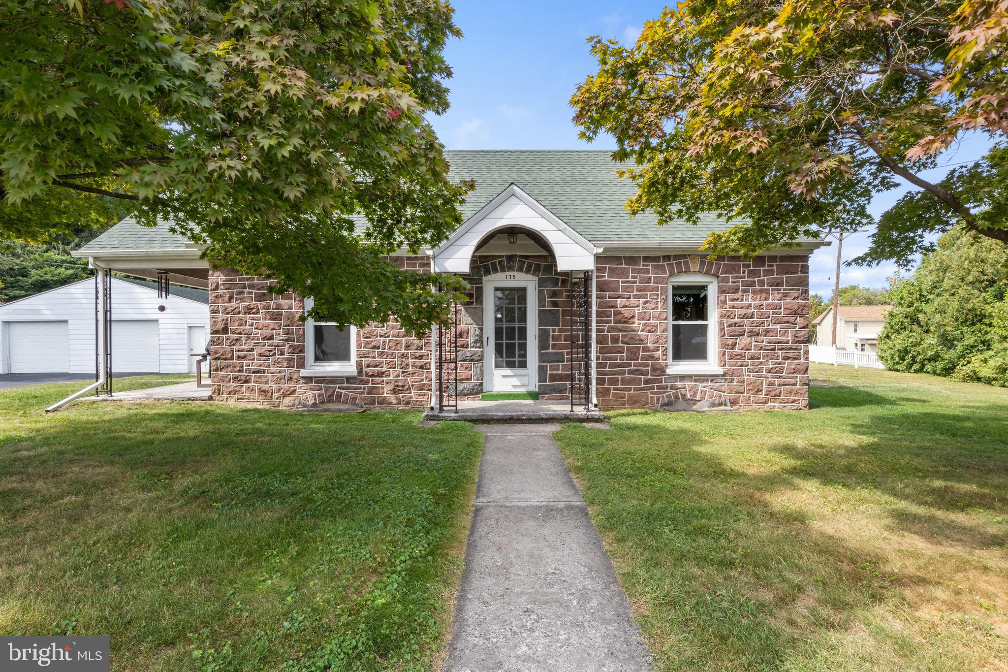 a front view of a house with a garden