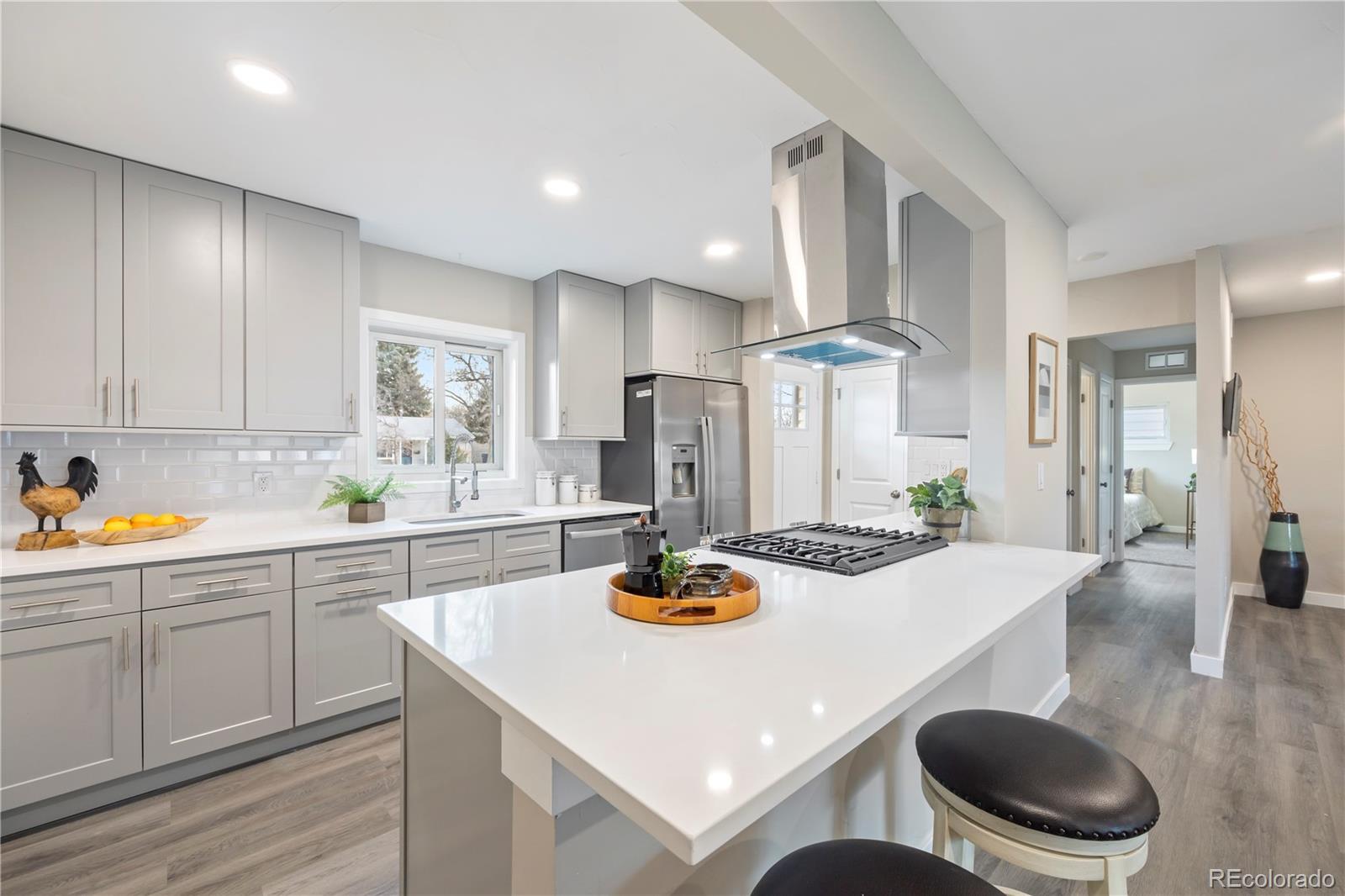 a kitchen with stainless steel appliances kitchen island granite countertop a sink and cabinets