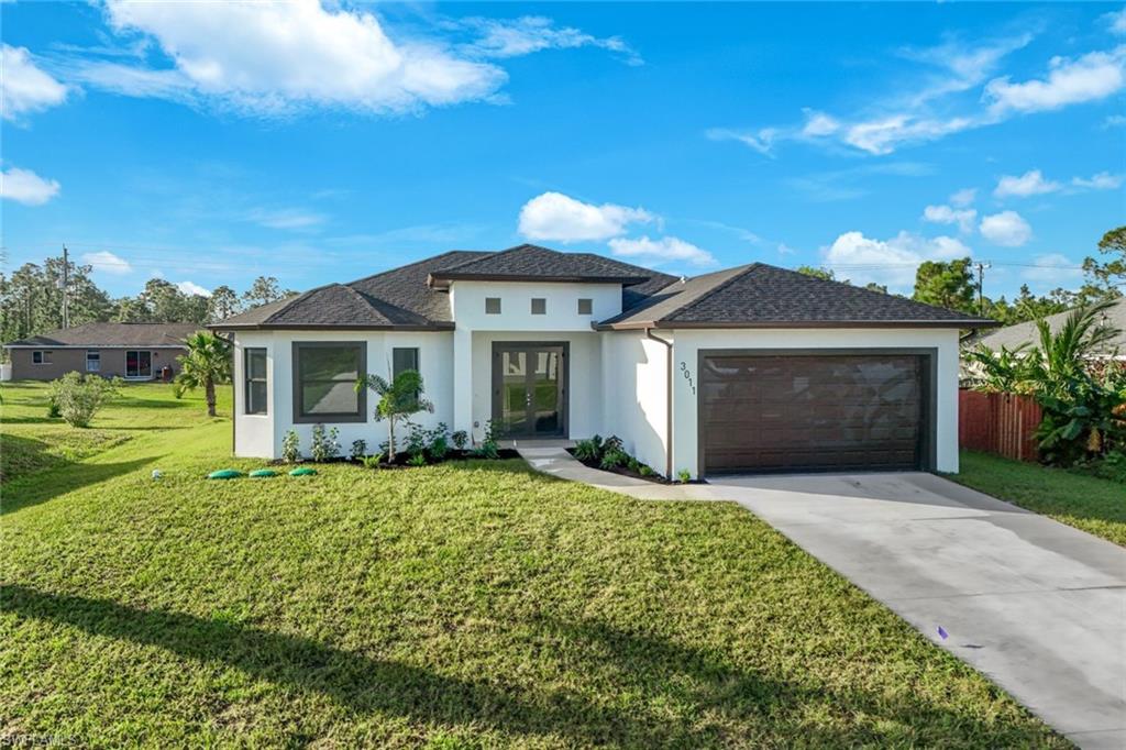 a front view of a house with a garden