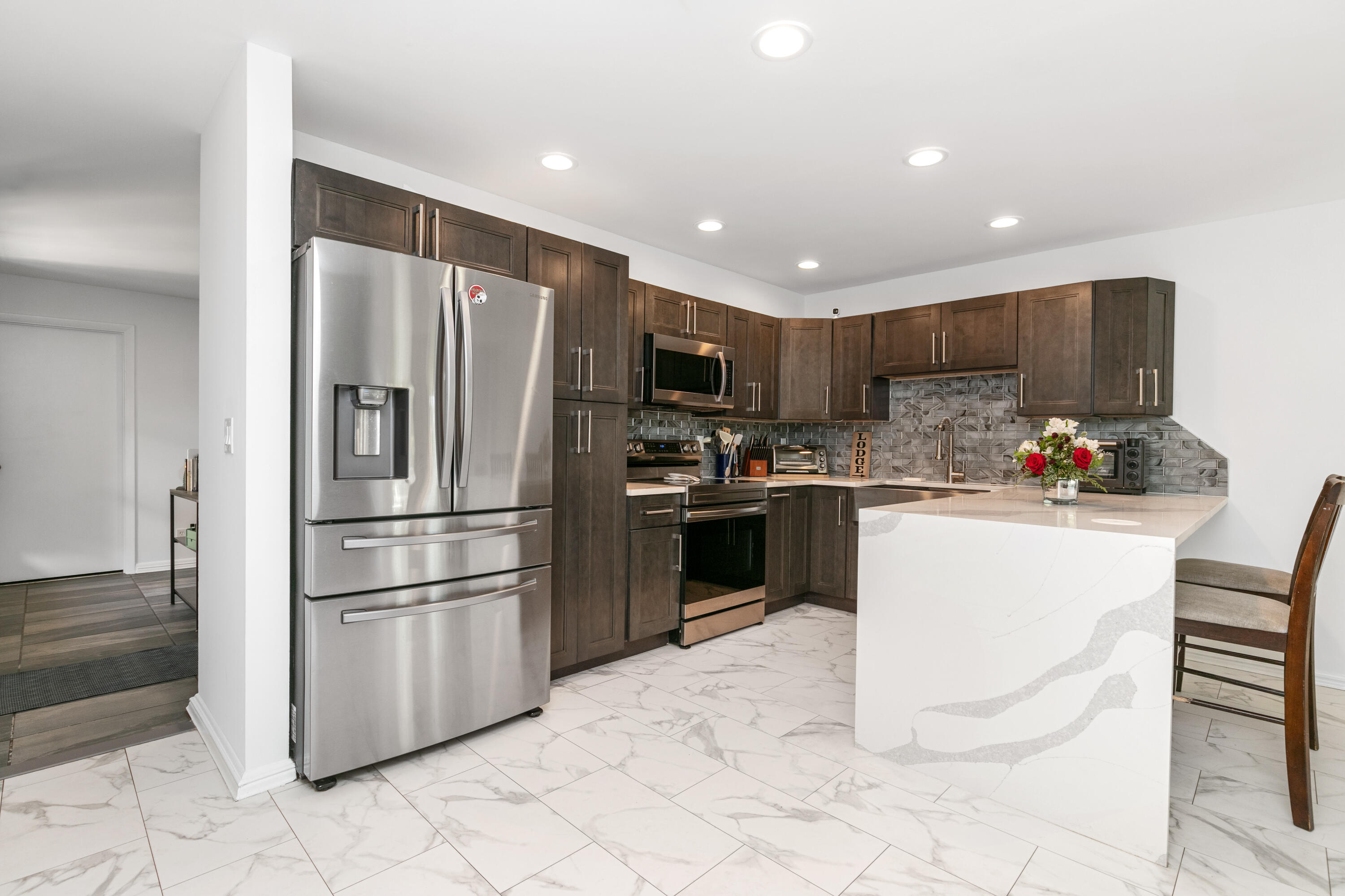 a kitchen with granite countertop a refrigerator and a sink