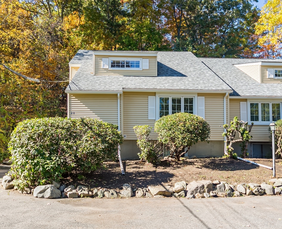 a front view of a house with a garden and patio