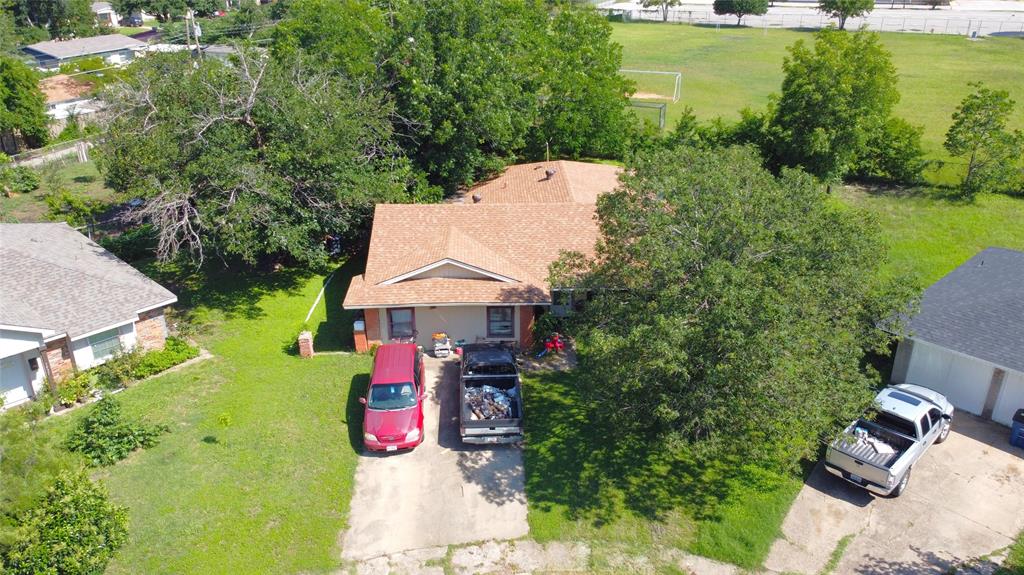 an aerial view of a house with a yard basket ball court and outdoor seating