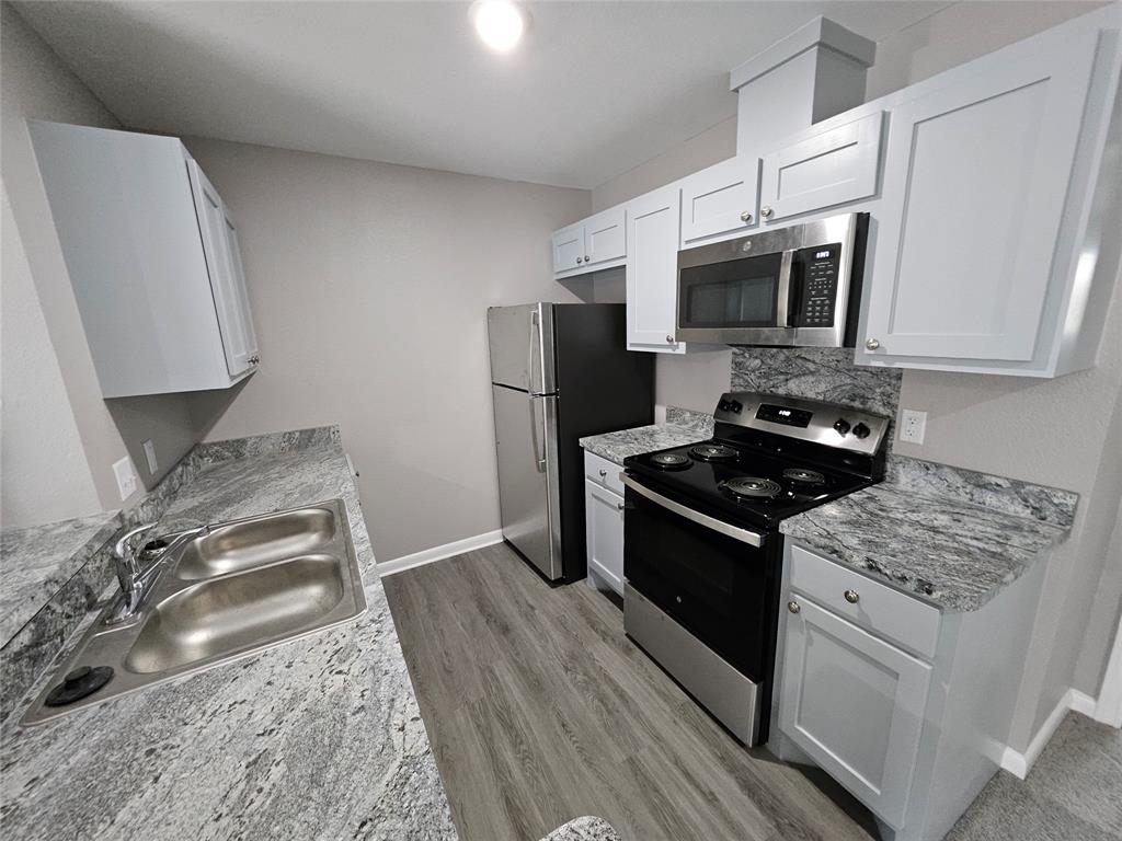 a kitchen with stainless steel appliances granite countertop a stove and a refrigerator