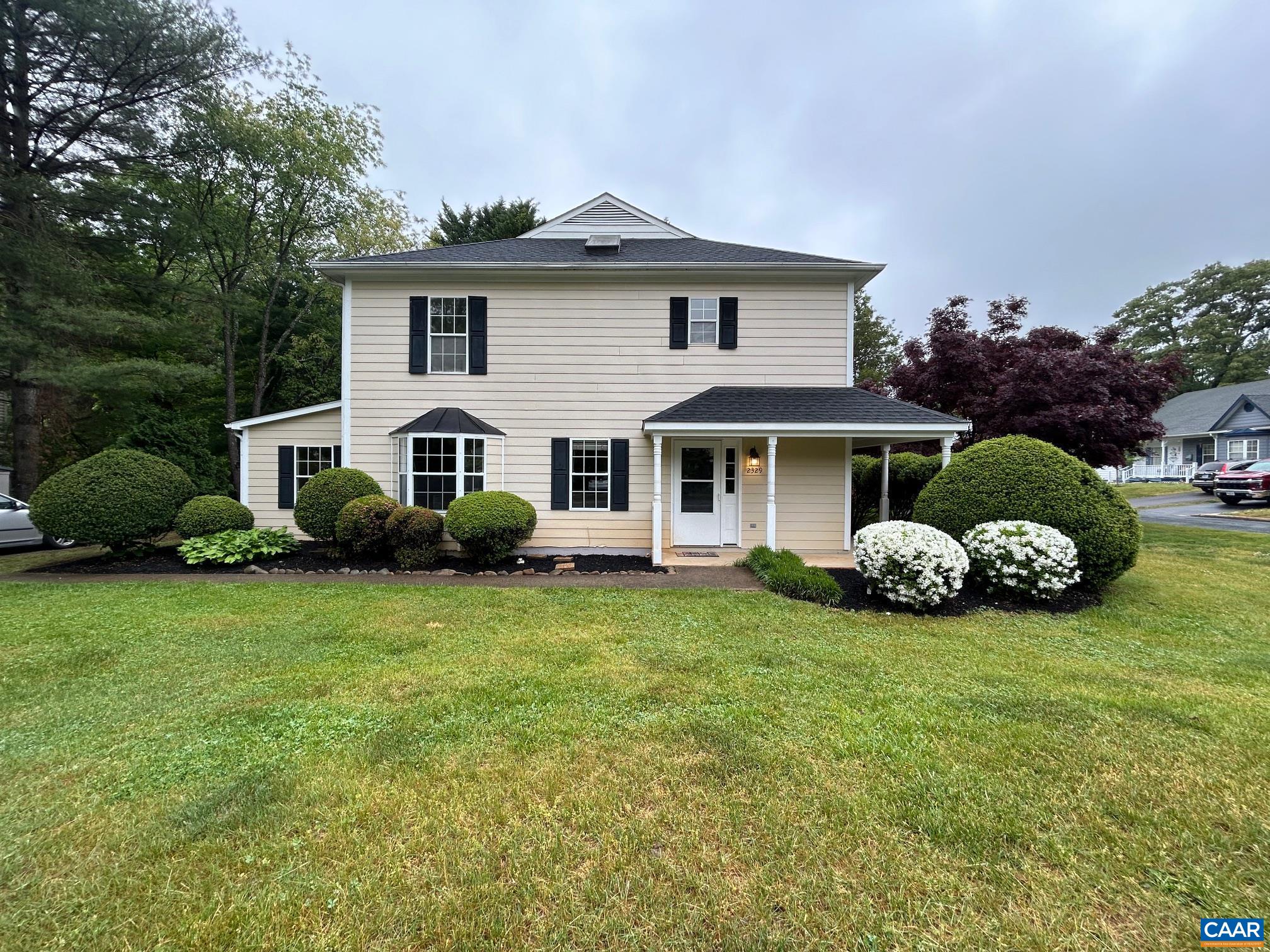 a front view of a house with a garden