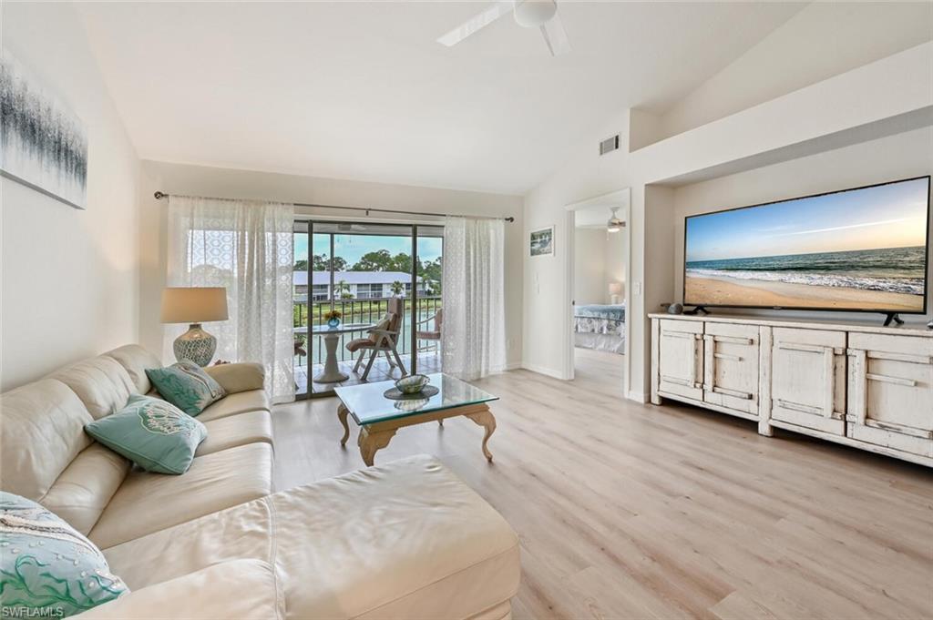 a living room with furniture and large windows