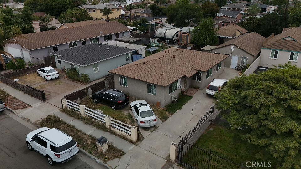 an aerial view of a house with swimming pool and outdoor seating