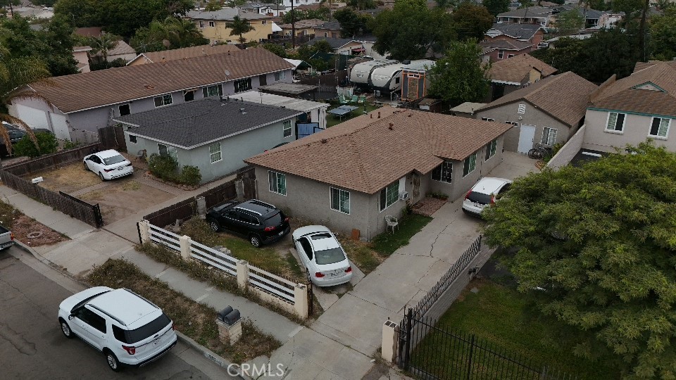 an aerial view of a house with swimming pool and outdoor seating