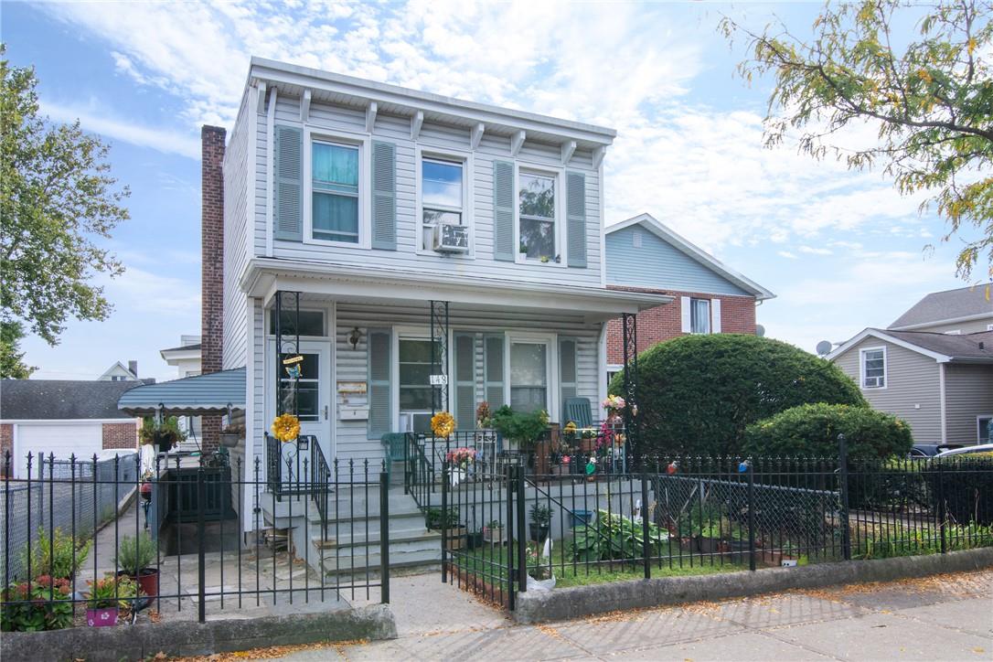 Italianate home featuring cooling unit and a porch