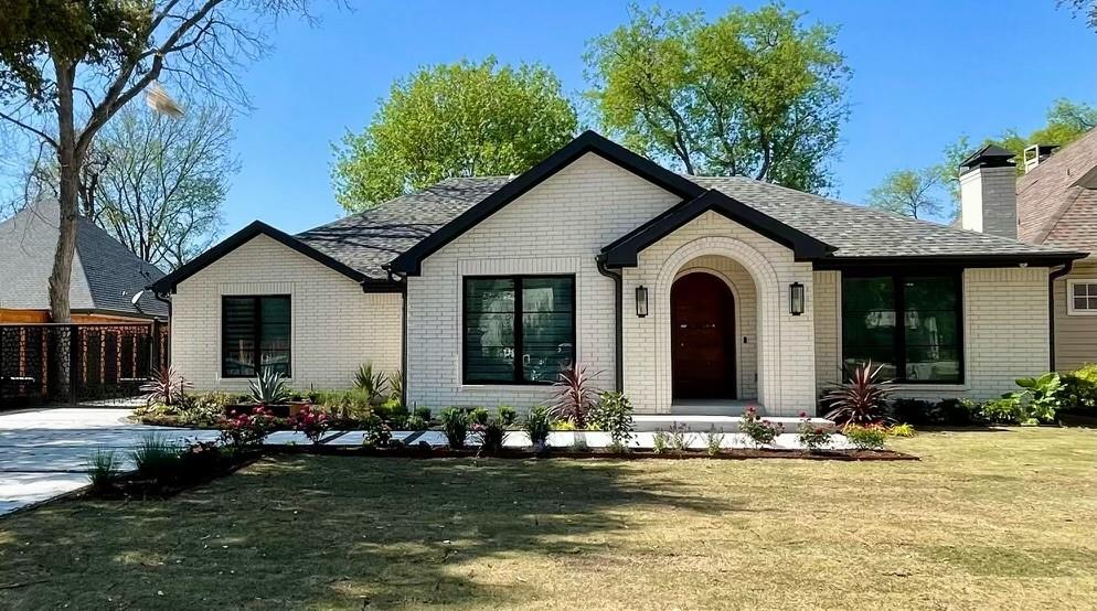 a front view of house with yard and outdoor seating