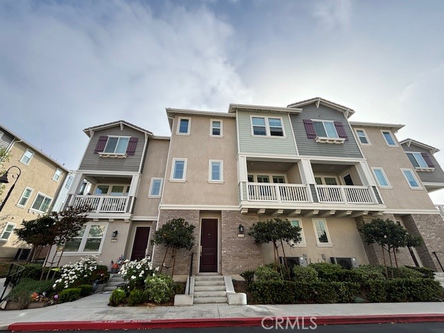 a front view of a residential apartment building with a yard