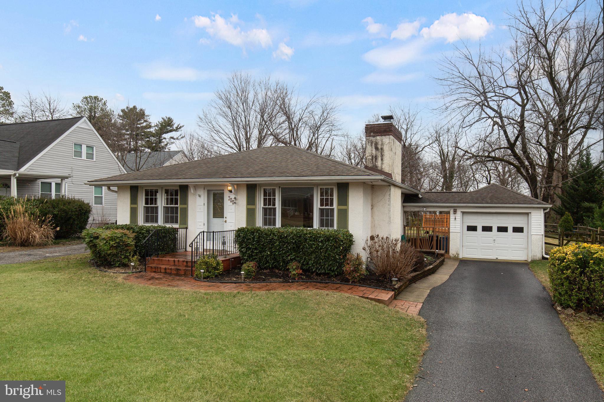 a front view of a house with yard and green space