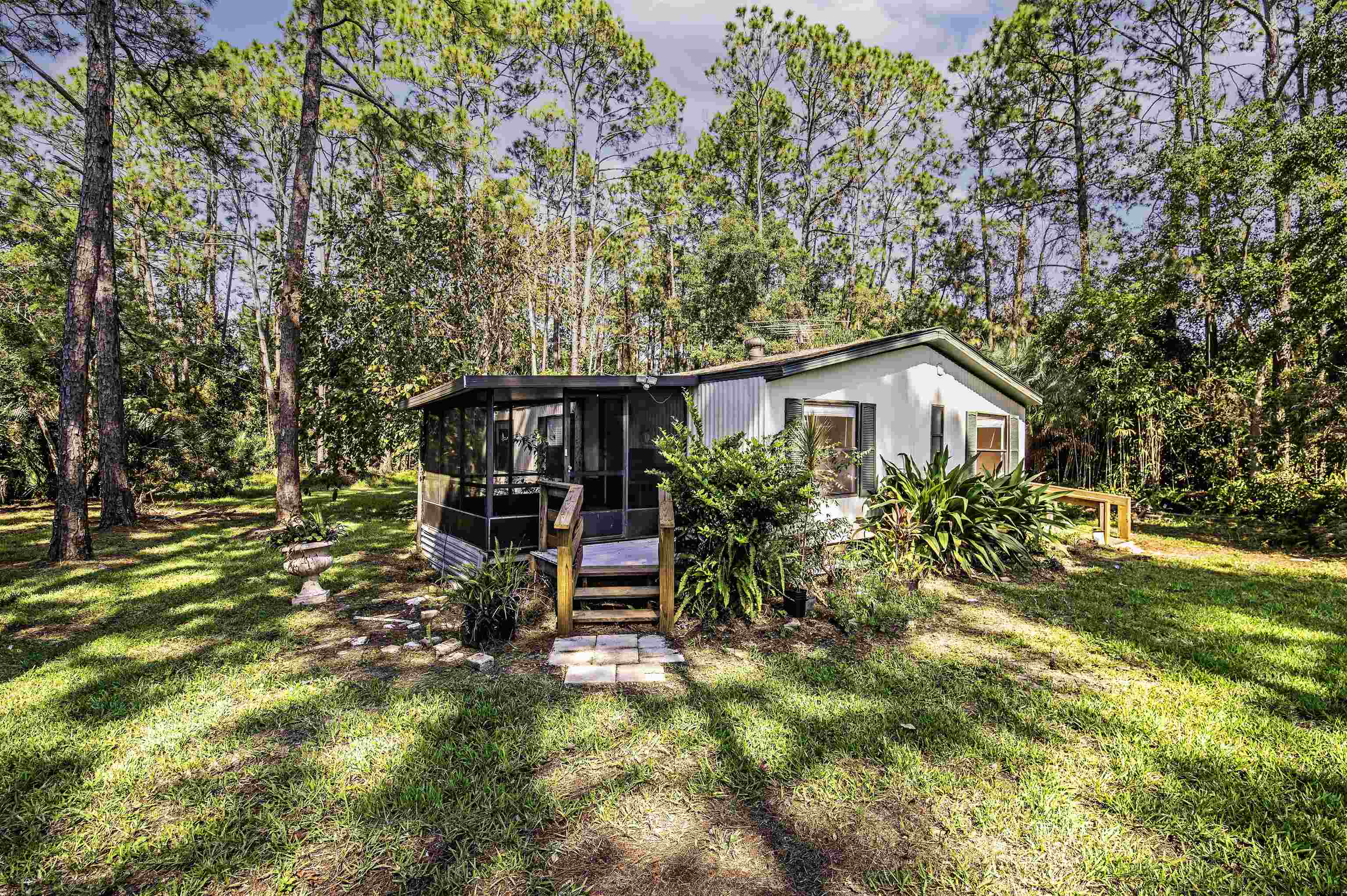 a view of a house with backyard sitting area and garden