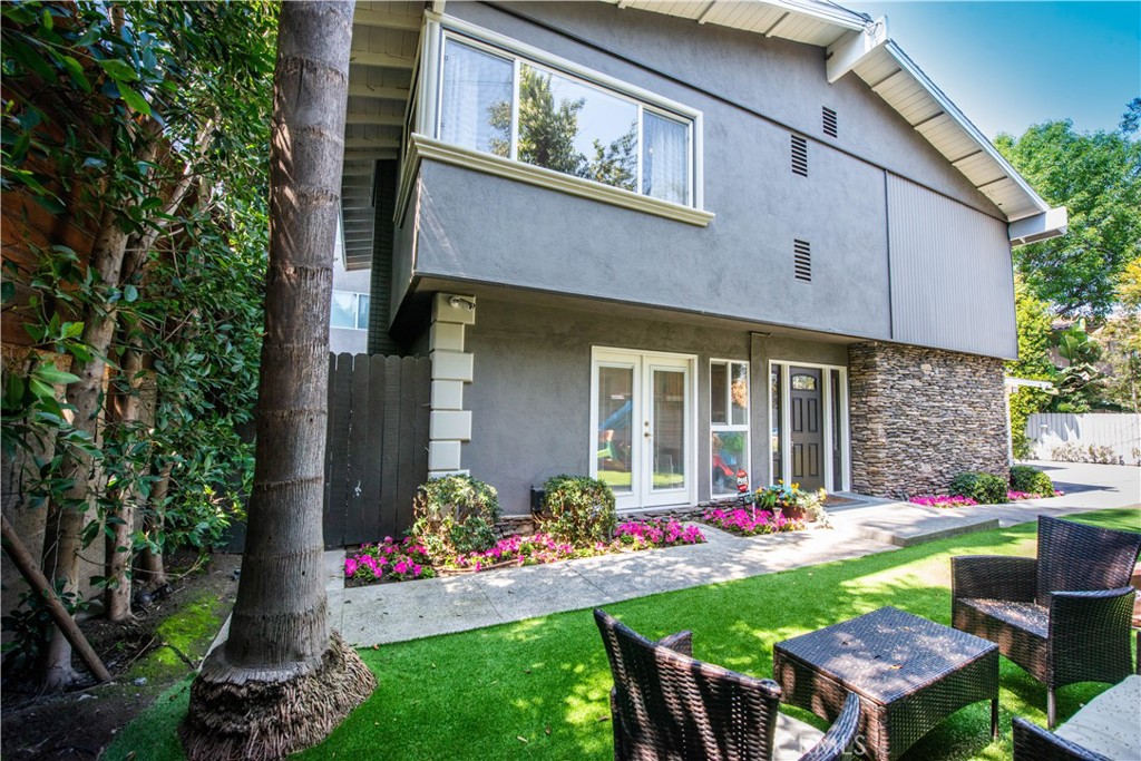 a view of a house with a yard and sitting area