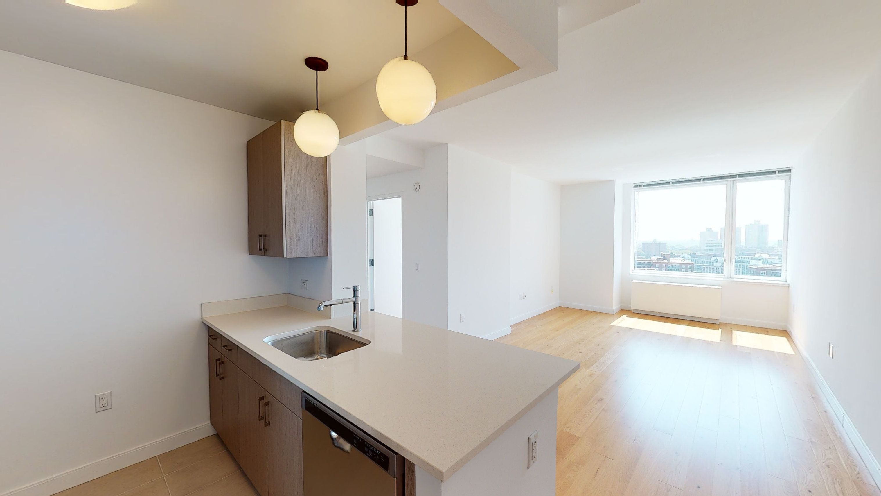 a kitchen with a sink dishwasher and a stove with wooden floor