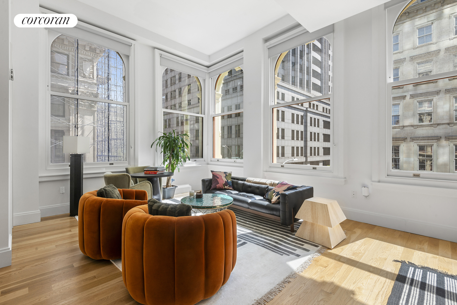 a living room with furniture and large windows