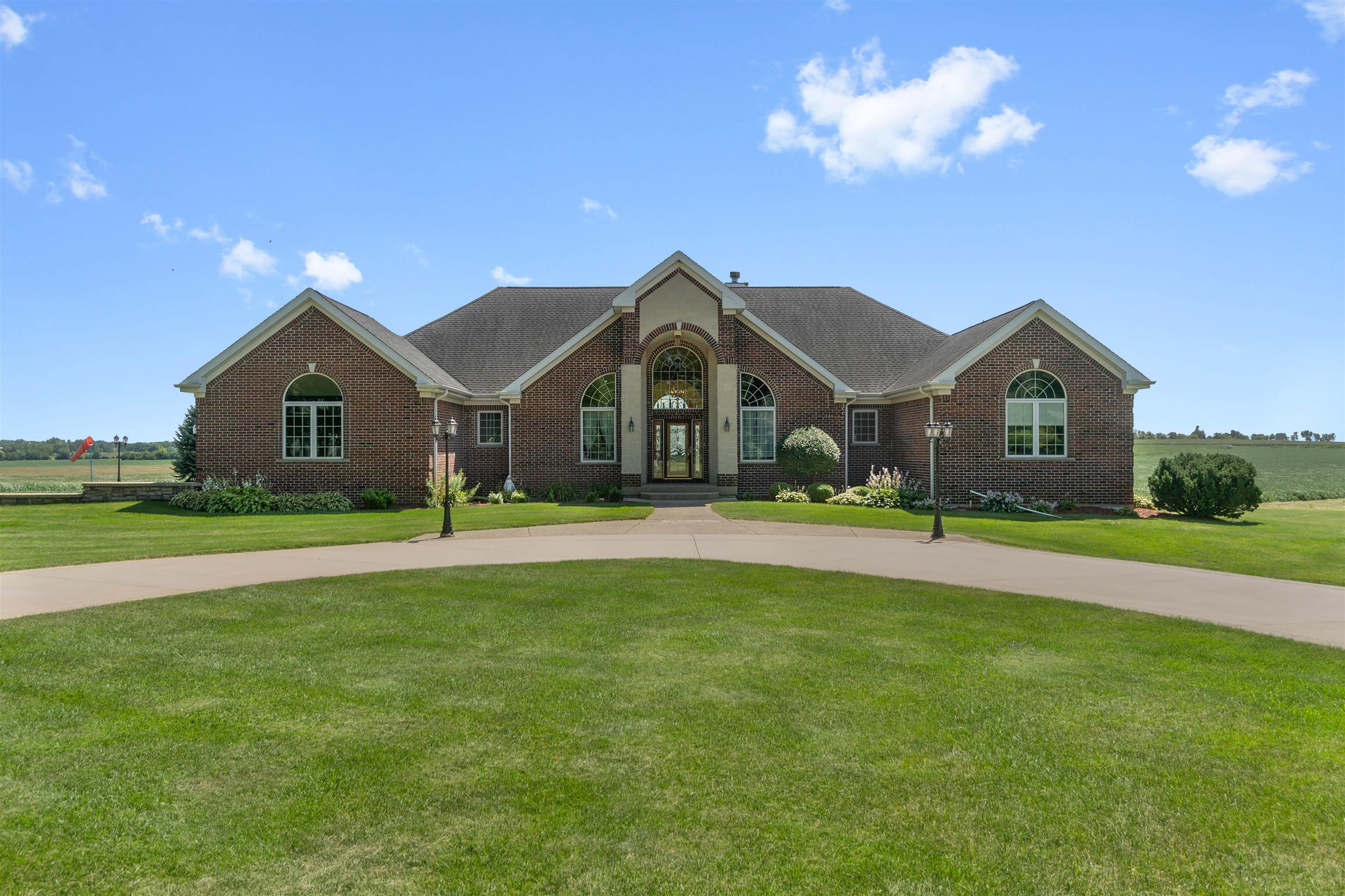 a front view of a house with a garden and yard